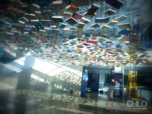 Artist Richard Wentworth supervises from underneath his False Ceiling - Indianapolis installation