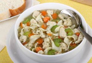 Chicken and noodle soup in a white bowl