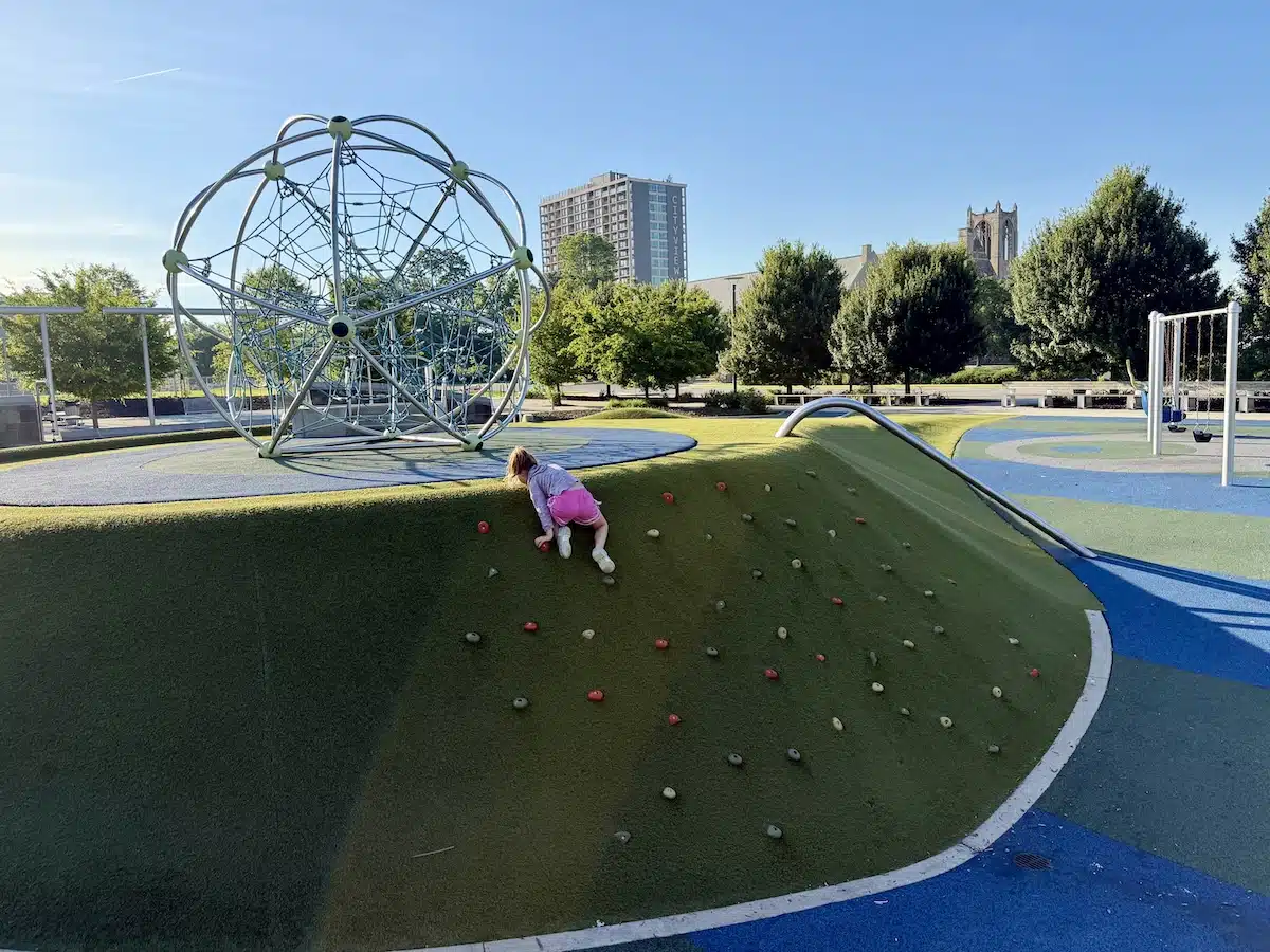 10 Coolest Playgrounds in the Indianapolis Area 13 girl climbing rock wall hill at Tarkington Park9