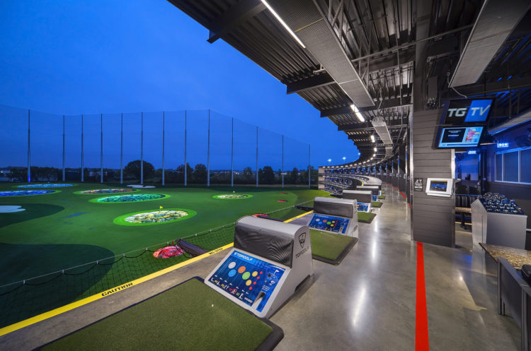 Top 15 Things to Do in Fishers with Kids (2025) 10 Family teeing off in covered bay at Topgolf Fishers