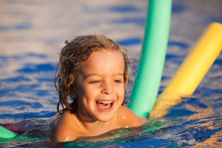 Happy child swimming