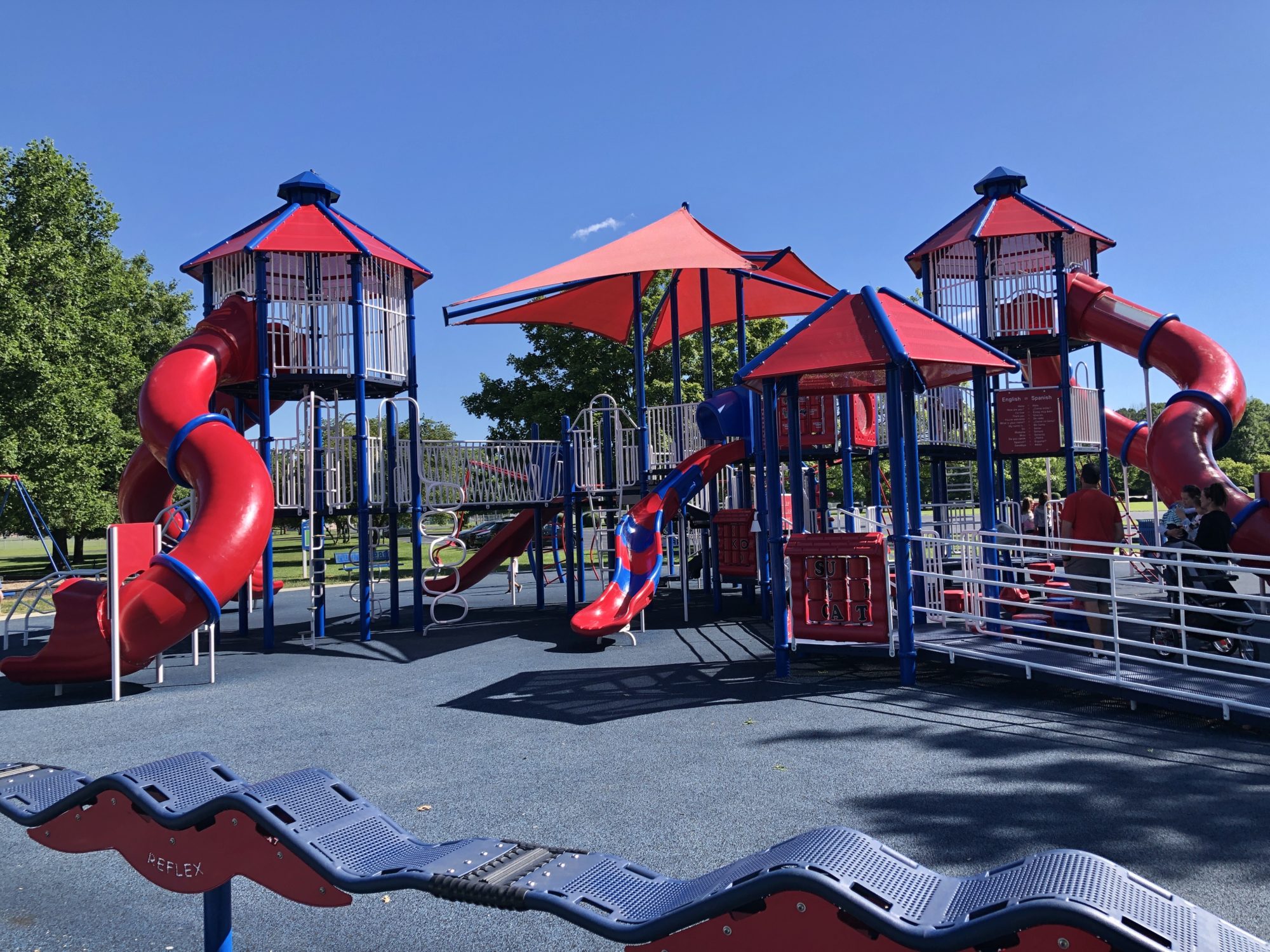 Red and blue playground towers with twisting tube slides at Hummel Park in Plainfield