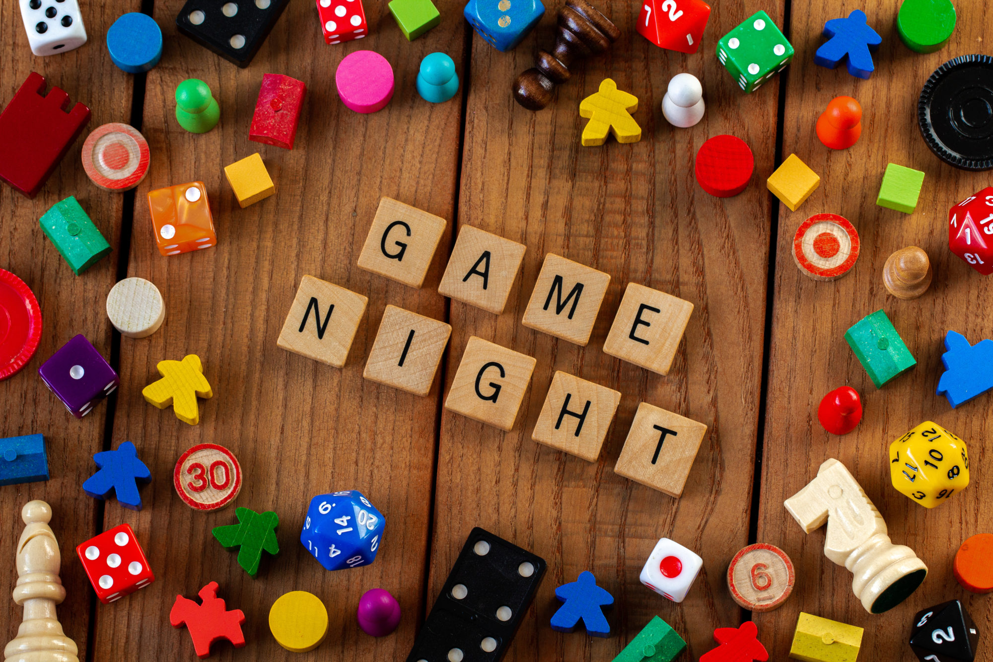 Game pieces and wooden tiles spelling Game Night