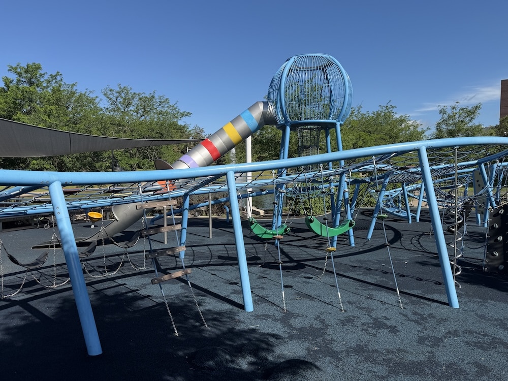 Blue rope climbing course and net walkway at Colts Canal Playground in Indianapolis