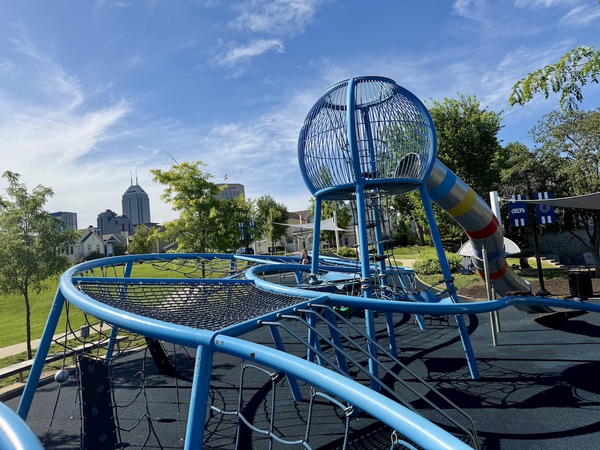 Colts Canal Playground climbing structure with downtown Indianapolis buildings in the background