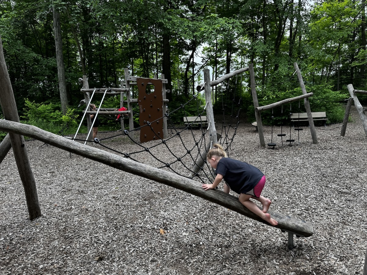 Climbing on the playground at Nature Adventure Playground at Jill Perelman Pavilion