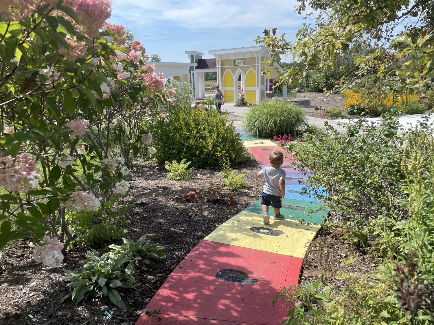 Playhouses and paths in the Children's Garden at Coxhall Gardens