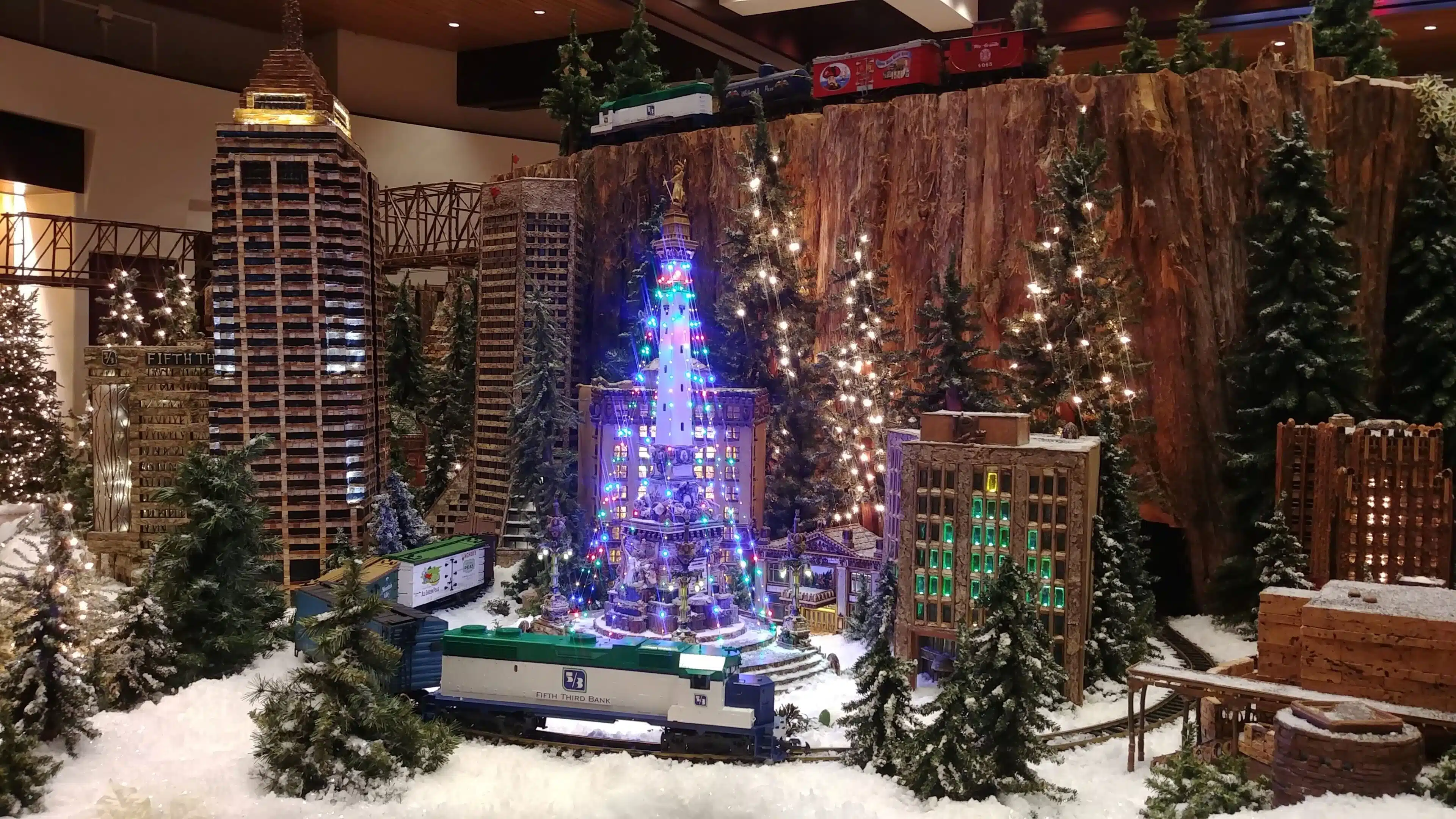 Things to Do This Weekend in Indianapolis with Kids (Nov 21-23, 2025) 2 Model trains and Monument Circle scene at Jingle Rails in the Eiteljorg Museum