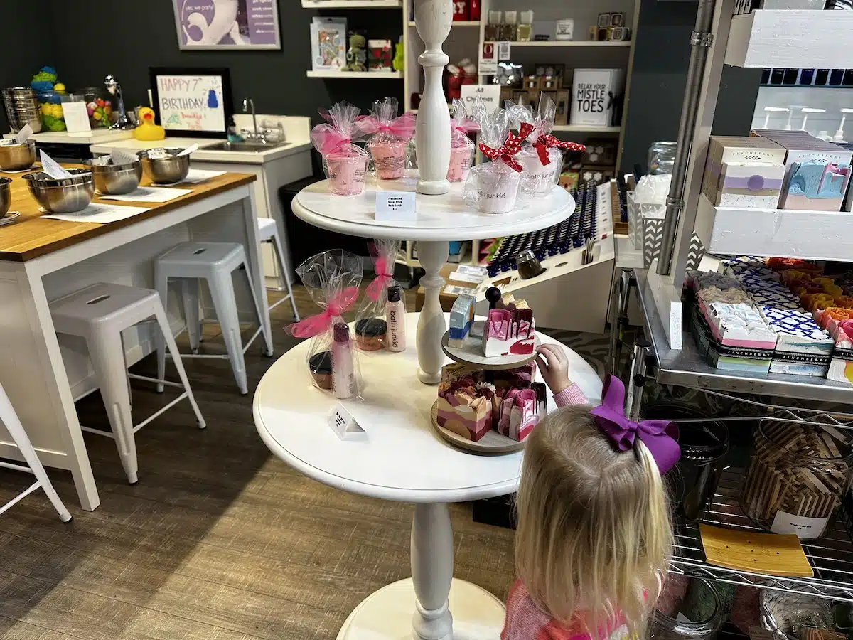 A young girl looks over a display of bath products at Bath Junkie in Carmel City Center