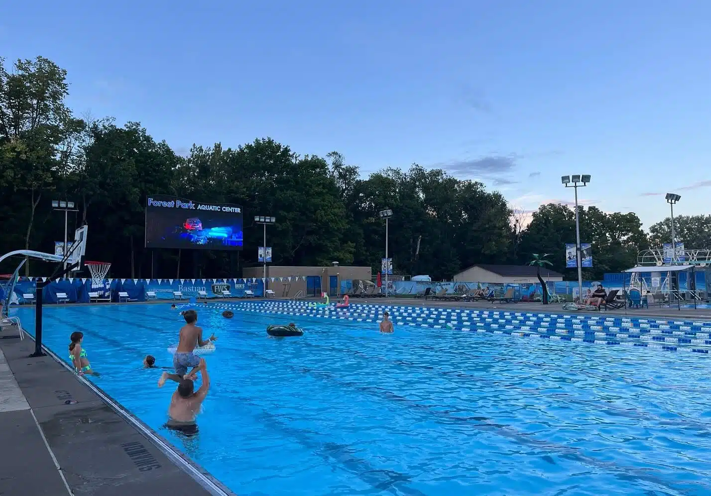 Families watching a movie poolside at Forest Park Aquatic Center in Noblesville