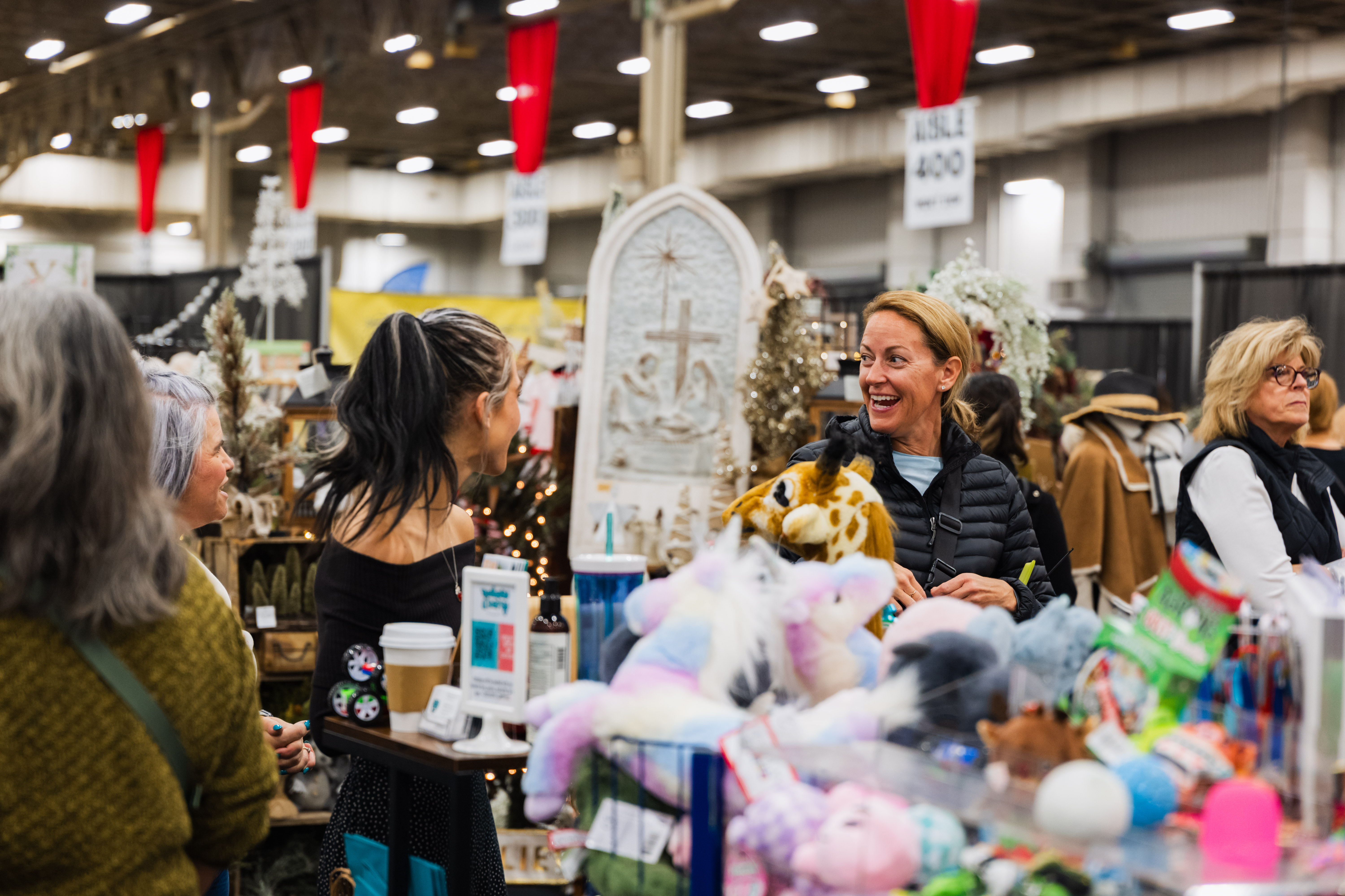 Shoppers browse a booth of plush toys and gifts at the Junior League of Indianapolis Holiday Mart