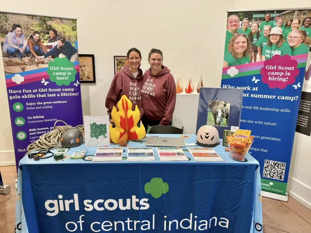 Two Girl Scouts of Central Indiana staff members at their camp booth at the Indy’s Child Summer Camp Fair
