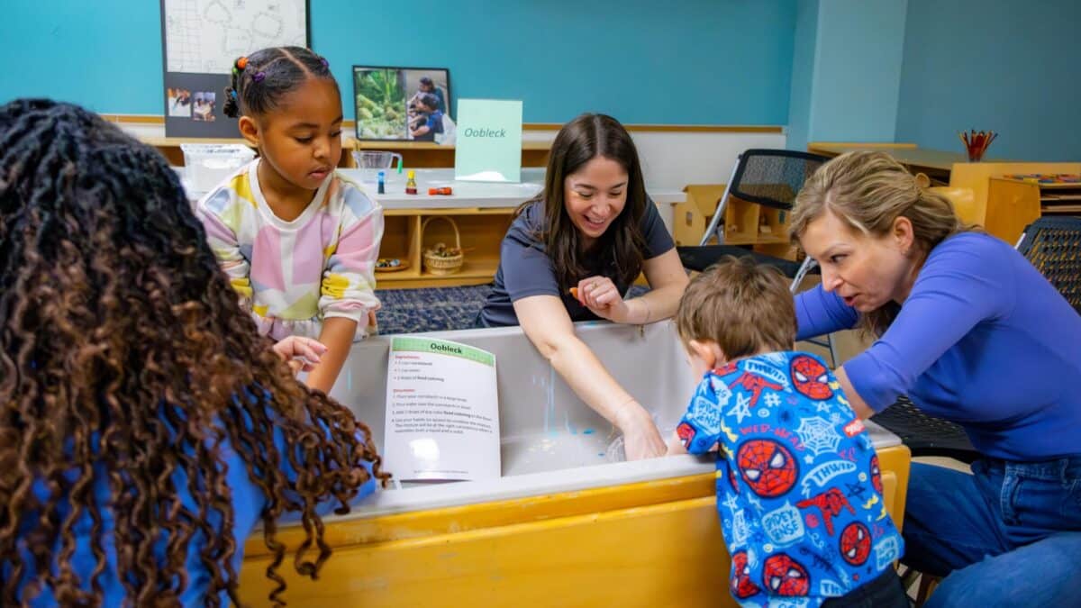 Children and parents doing a hands-on science experiment at The Children's Museum of Indianapolis