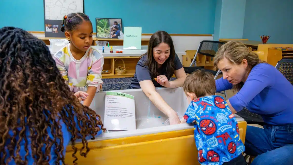 Children and parents doing a hands-on science experiment at The Children's Museum of Indianapolis