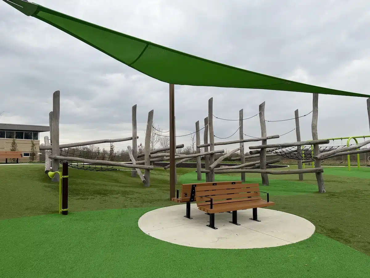 Shaded benches and seating for parents at Grassy Creek Park playground in Indianapolis