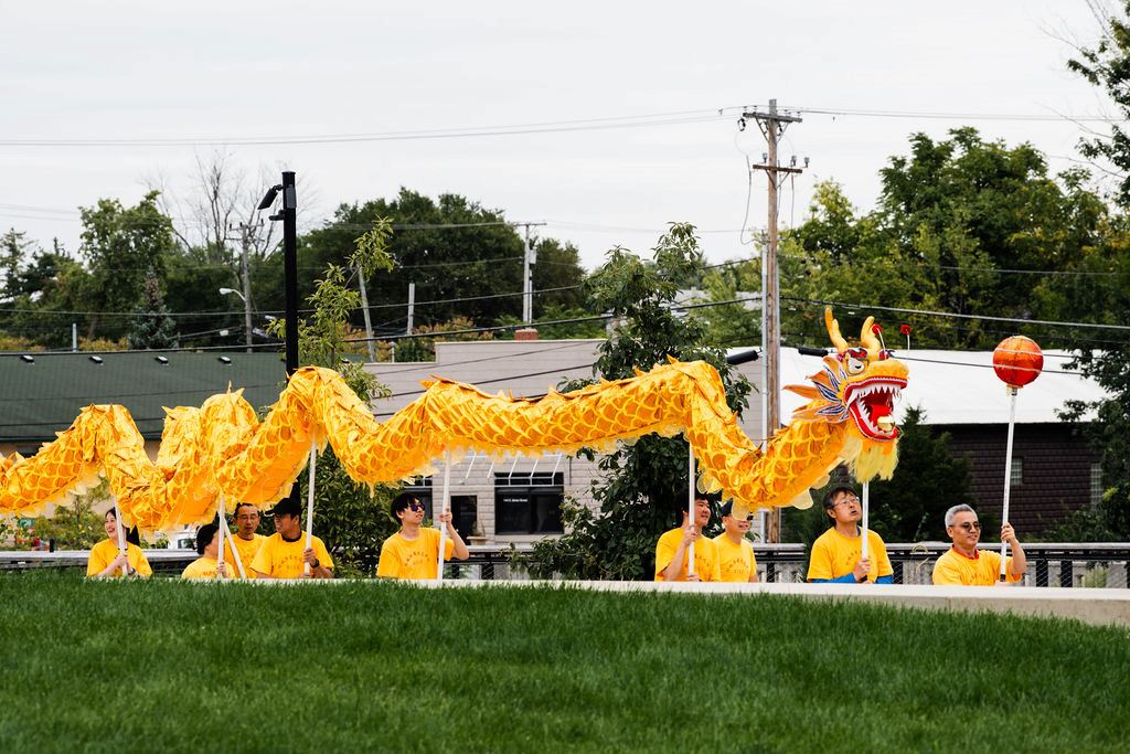 Performers carrying a yellow dragon during Westfield International Festival