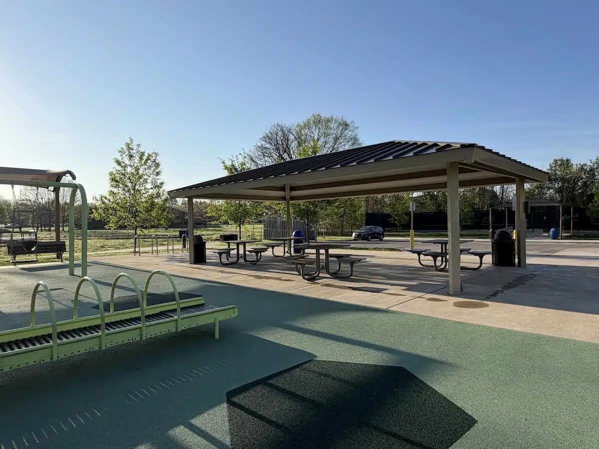 Picnic shelter with shaded tables next to the Meadowlark Park playground in Carmel
