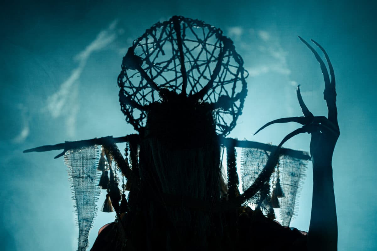 A haunt character with a twig crown and long claws in silhouette at Hanna Haunted Acres