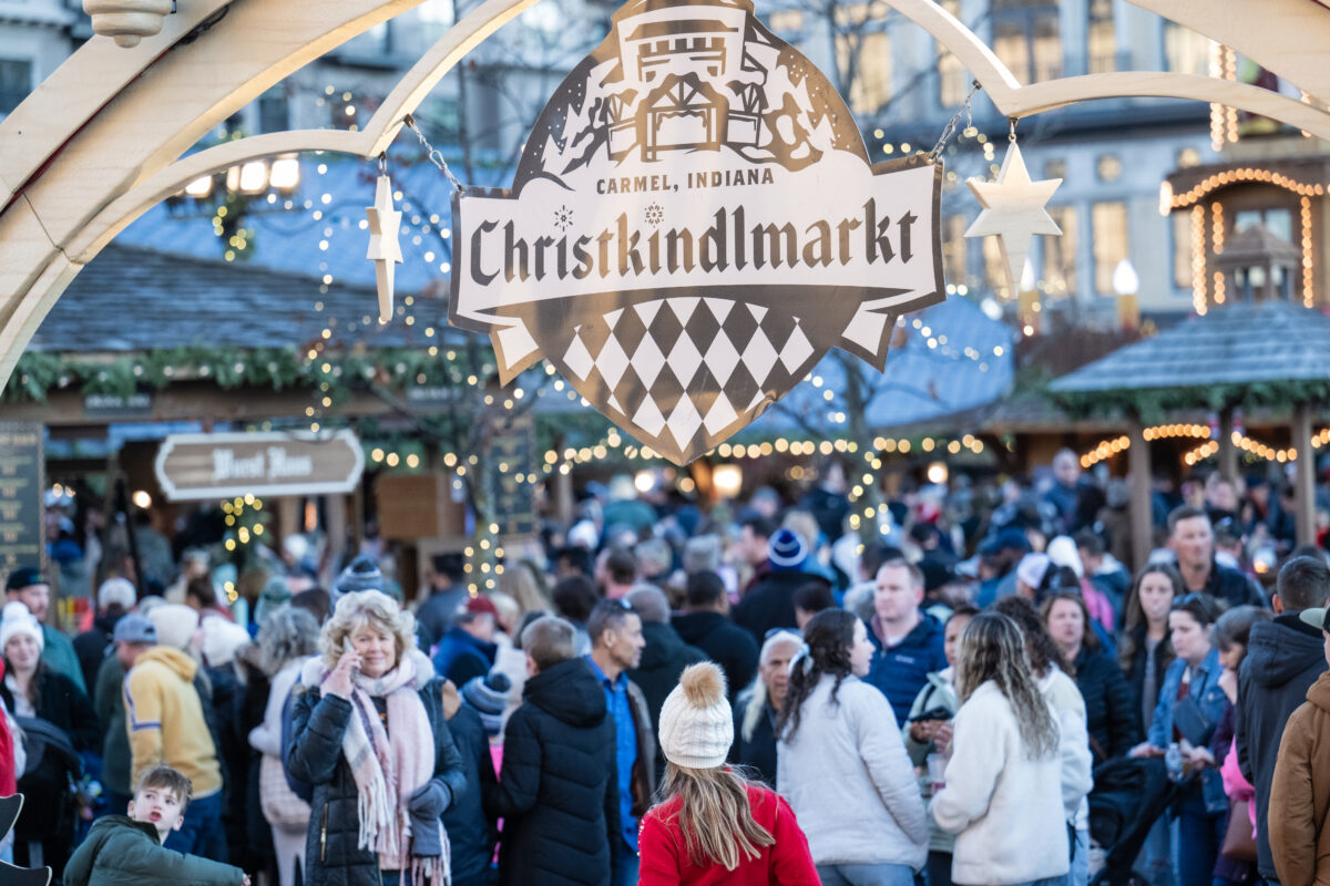 Crowds under the Christkindlmarkt sign on opening day at Carter Green in Carmel