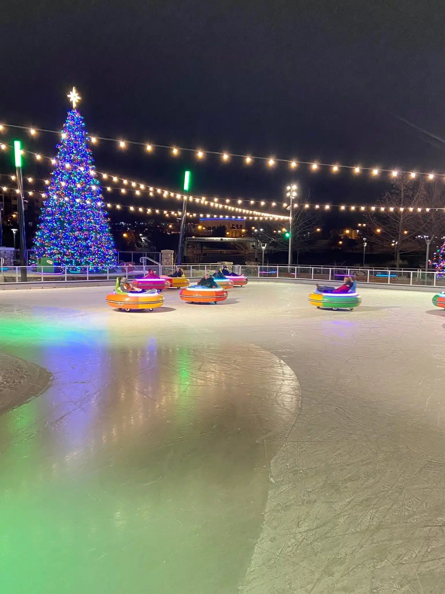 Family enjoying ice bumper cars at Ironworks Ice Rink in downtown Mishawaka