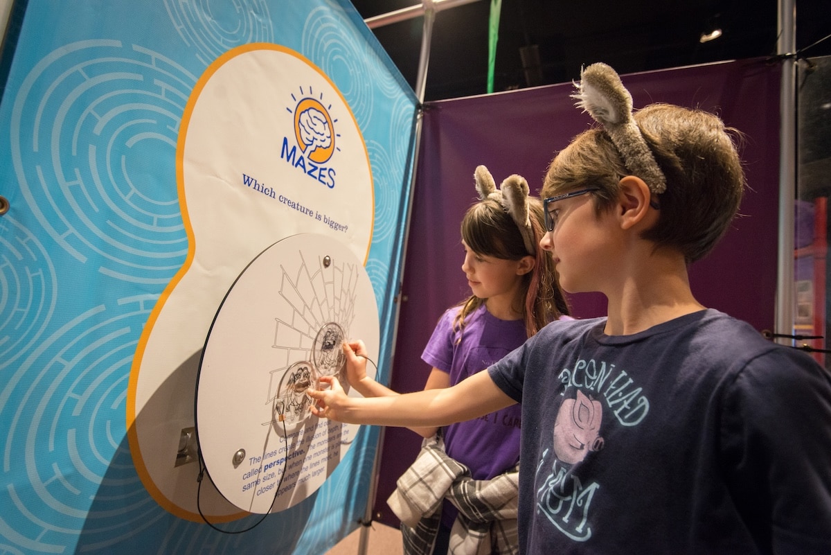 Mazes & Brain Games at the Indiana State Museum 4 Kids testing an optical illusion and perception challenge in the Mazes & Brain Games exhibit at the Indiana State Museum