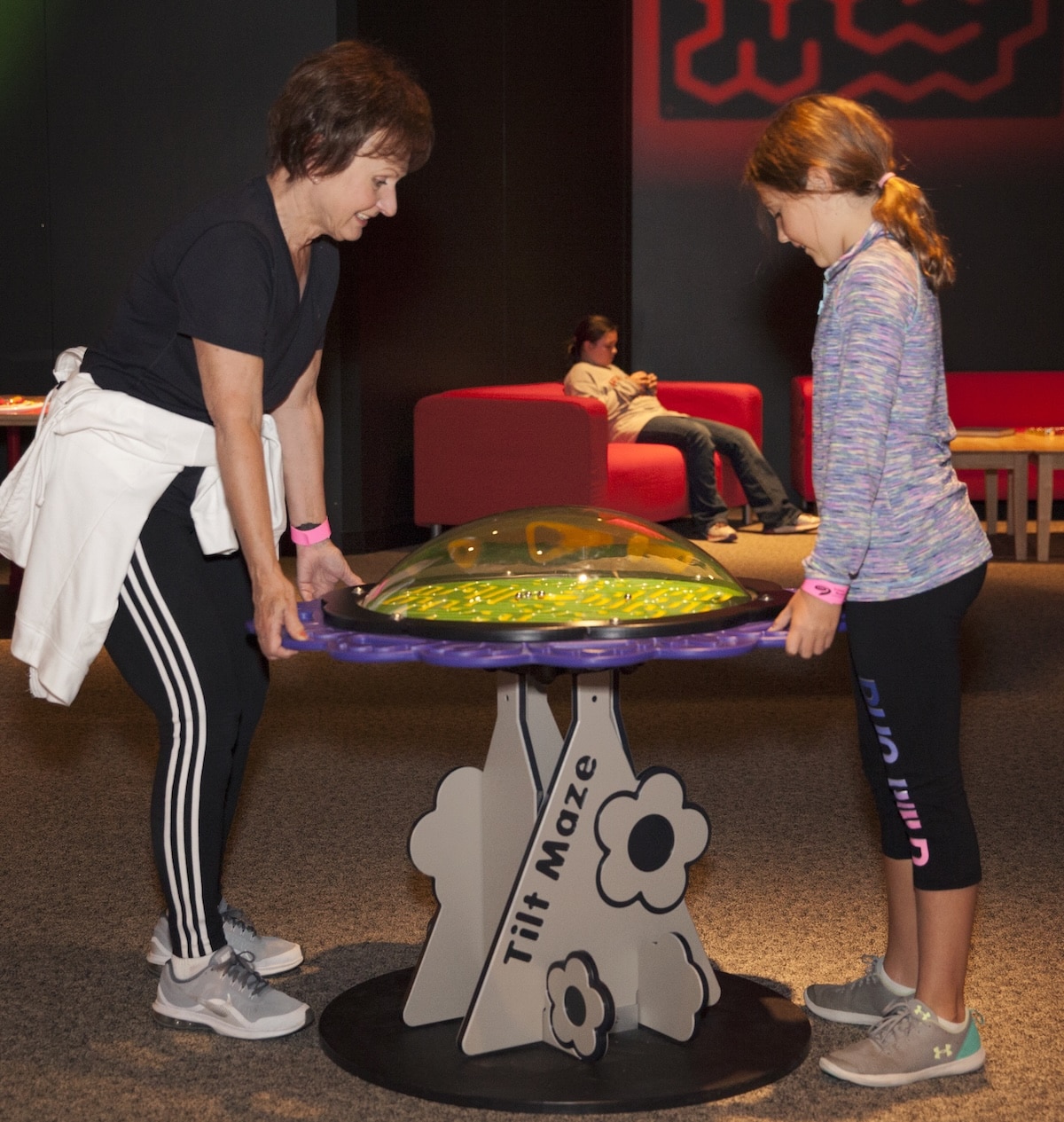 Mazes & Brain Games at the Indiana State Museum 2 Kids working together on the Tilt-a-Maze game in the Mazes & Brain Games exhibit at the Indiana State Museum
