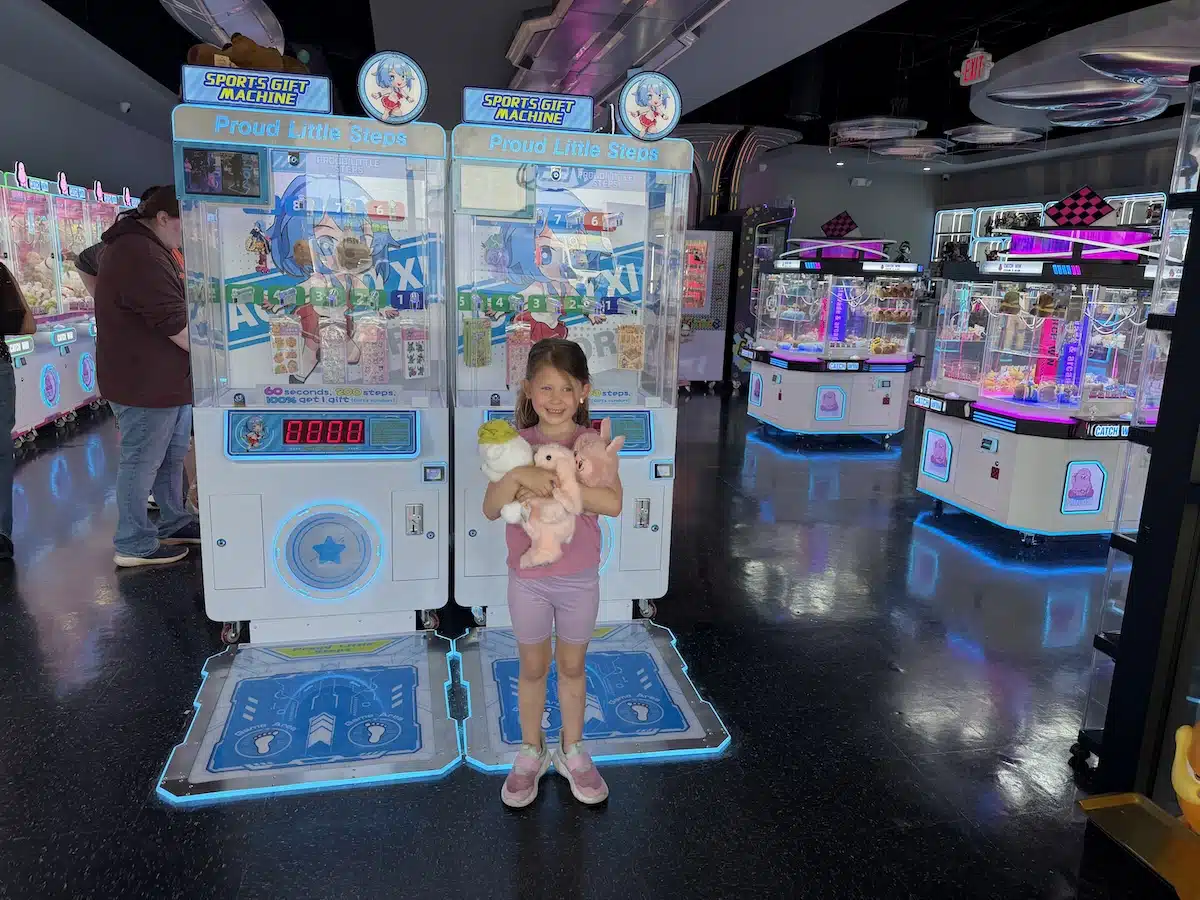 Holding her prizes at All-Claw-Machine Arcade in Indianapolis. 