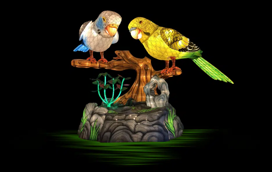 Colorful glowing parakeet lantern sculpture at Glo Wild lantern festival at the Fort Wayne Zoo