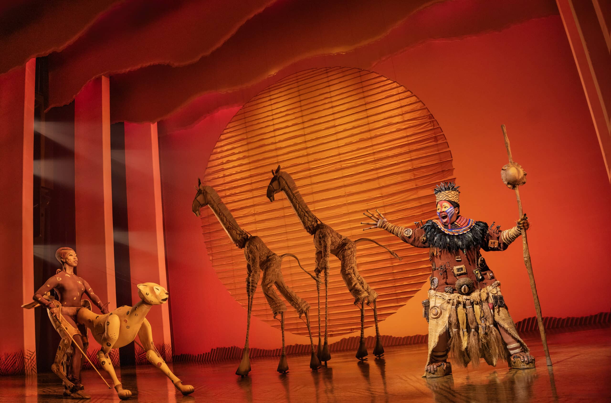 Ntsepa Pitjeng-Molebatsi as Rafiki with the company of Disney's The Lion King