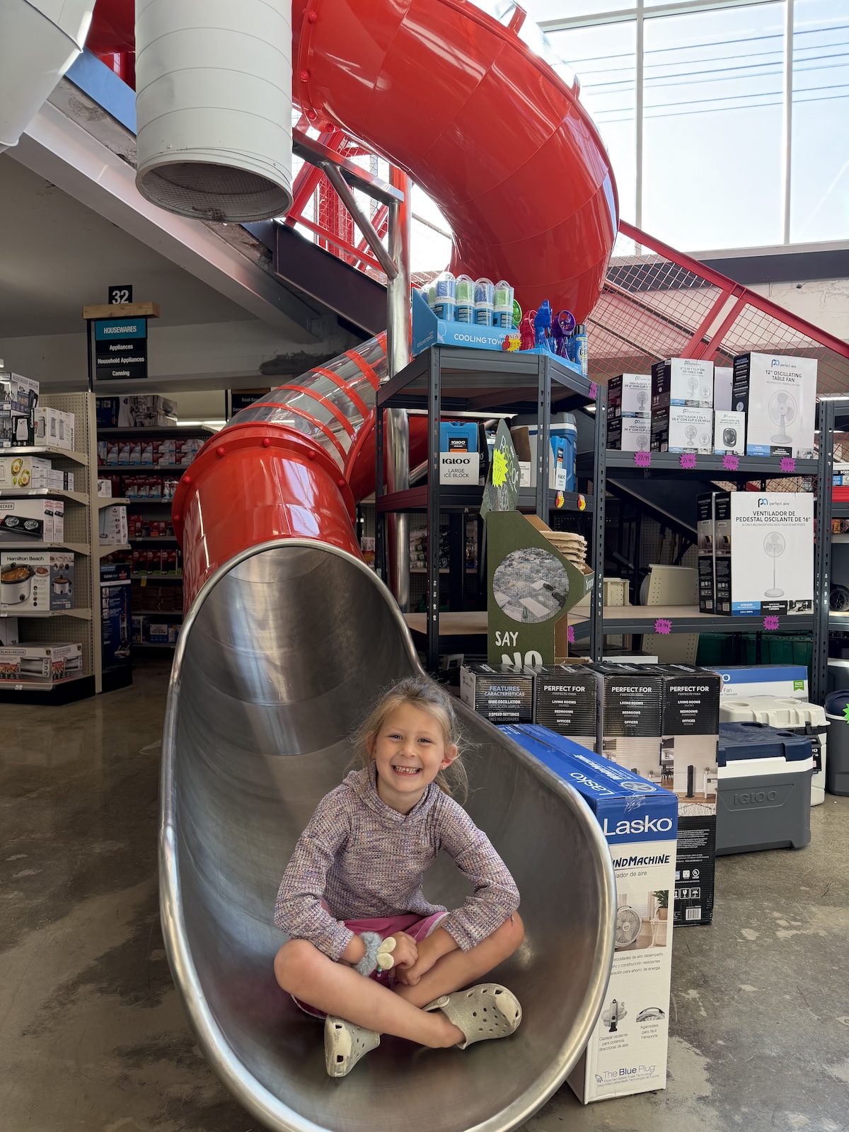 Ace Hardware With a Slide Inside in Indianapolis 1 Girl sitting at the bottom of the indoor slide at Benge's Ace Hardware in Indianapolis