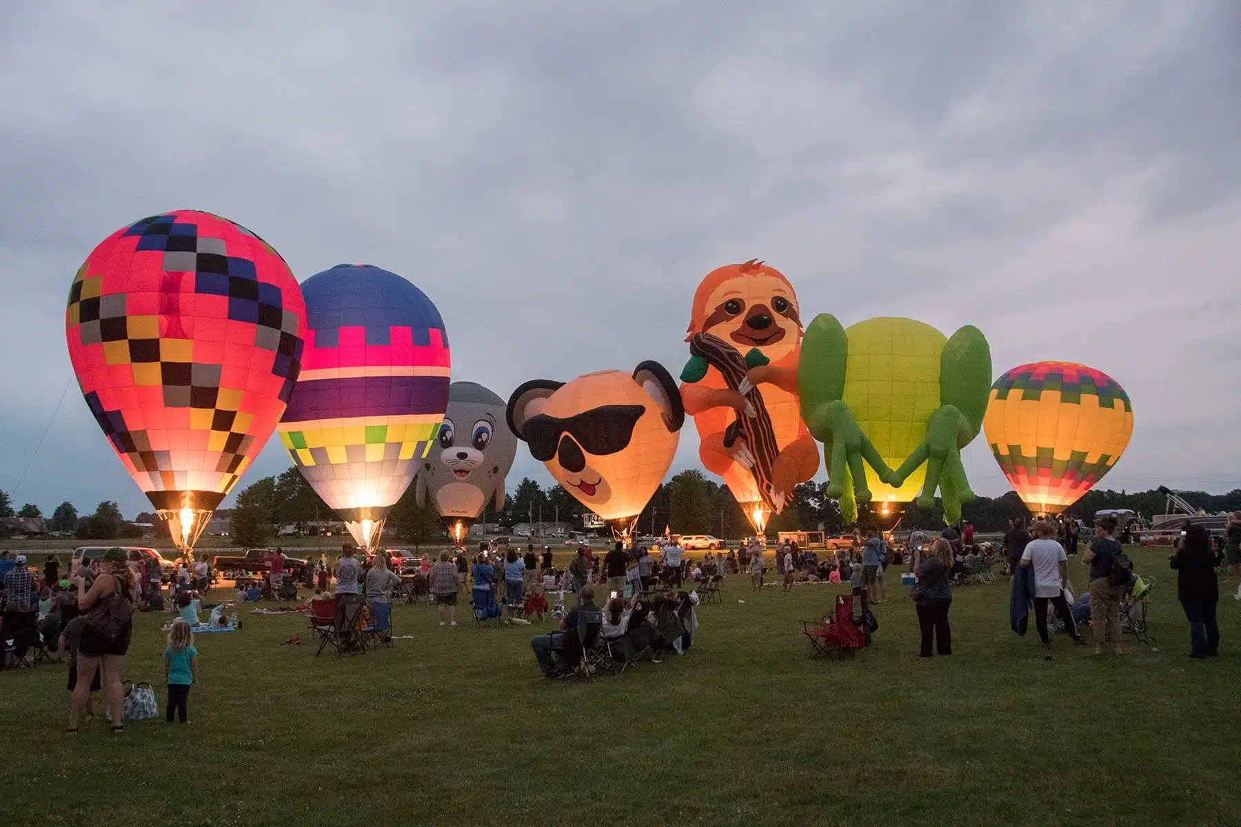 Hot air balloons glowing on the festival field at Angola Balloons Aloft
