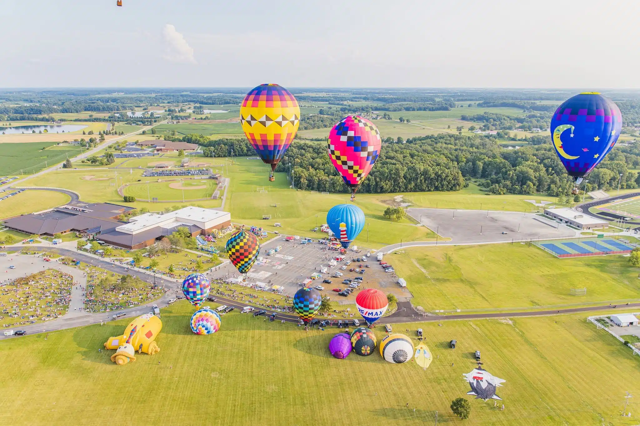 Hot air balloons launching from the field at Angola Balloons Aloft