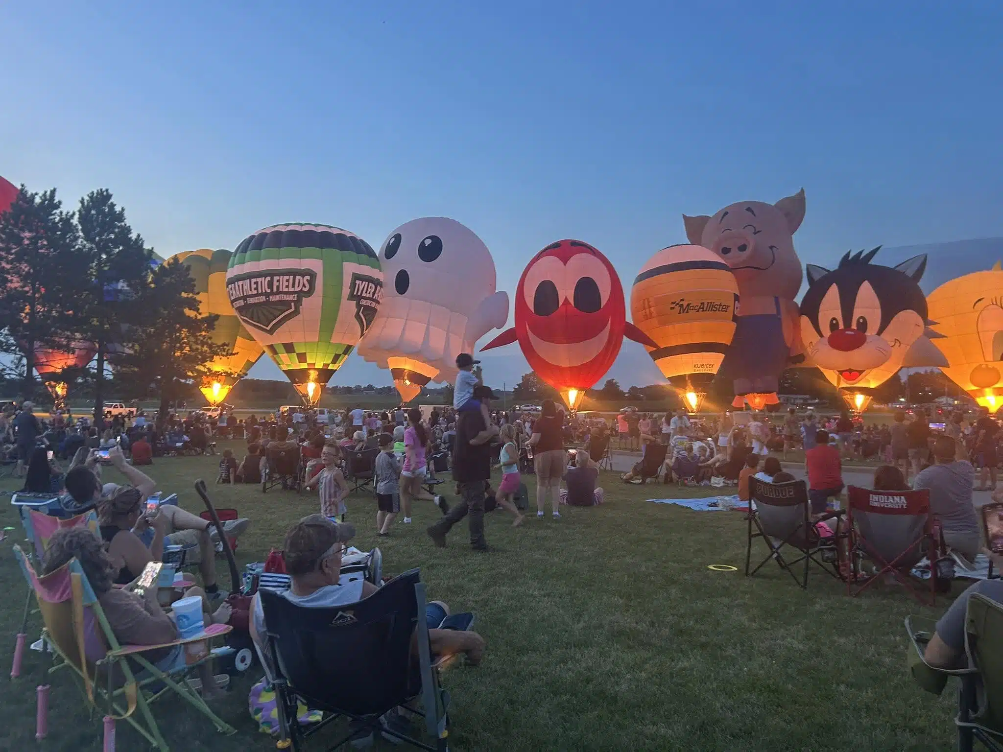 Crowd watching hot air balloons glow at Angola Balloons Aloft
