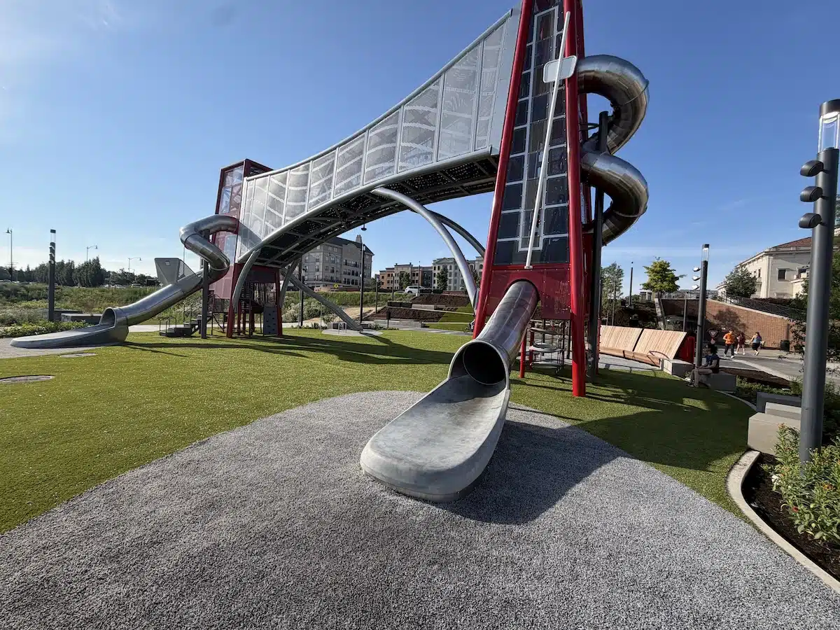 Carmel’s Huge New Monon Boulevard Playground 1 Up and Down the Monon playground with red climbing towers and tube slides in Carmel