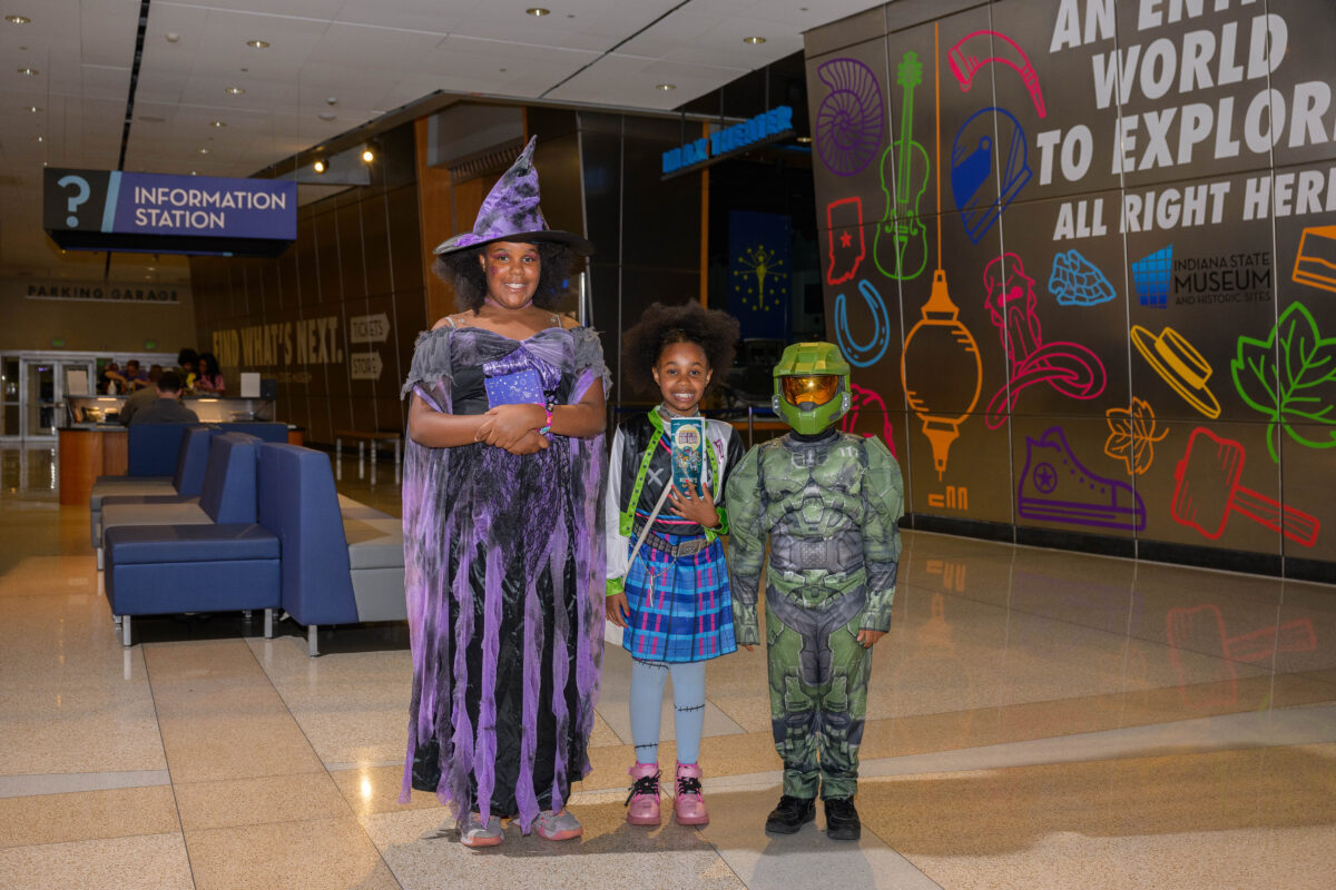 Costumed characters greeting children inside the Indiana State Museum