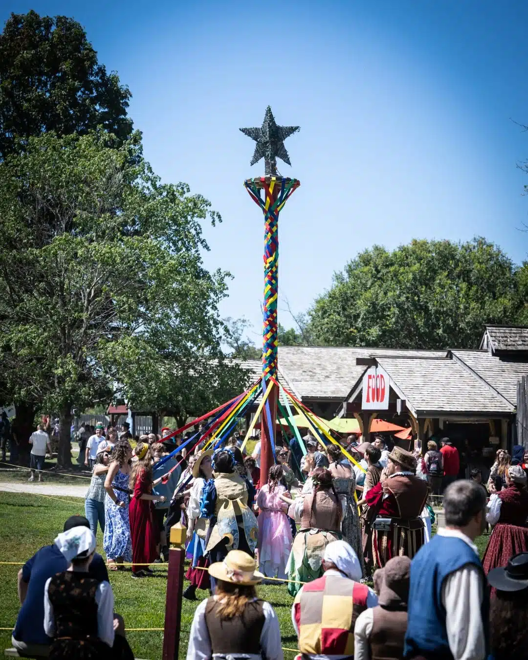 Ohio Renaissance Festival: A Day Trip From Indy With Kids 5 Festivalgoers dancing in a circle around a maypole with ribbons