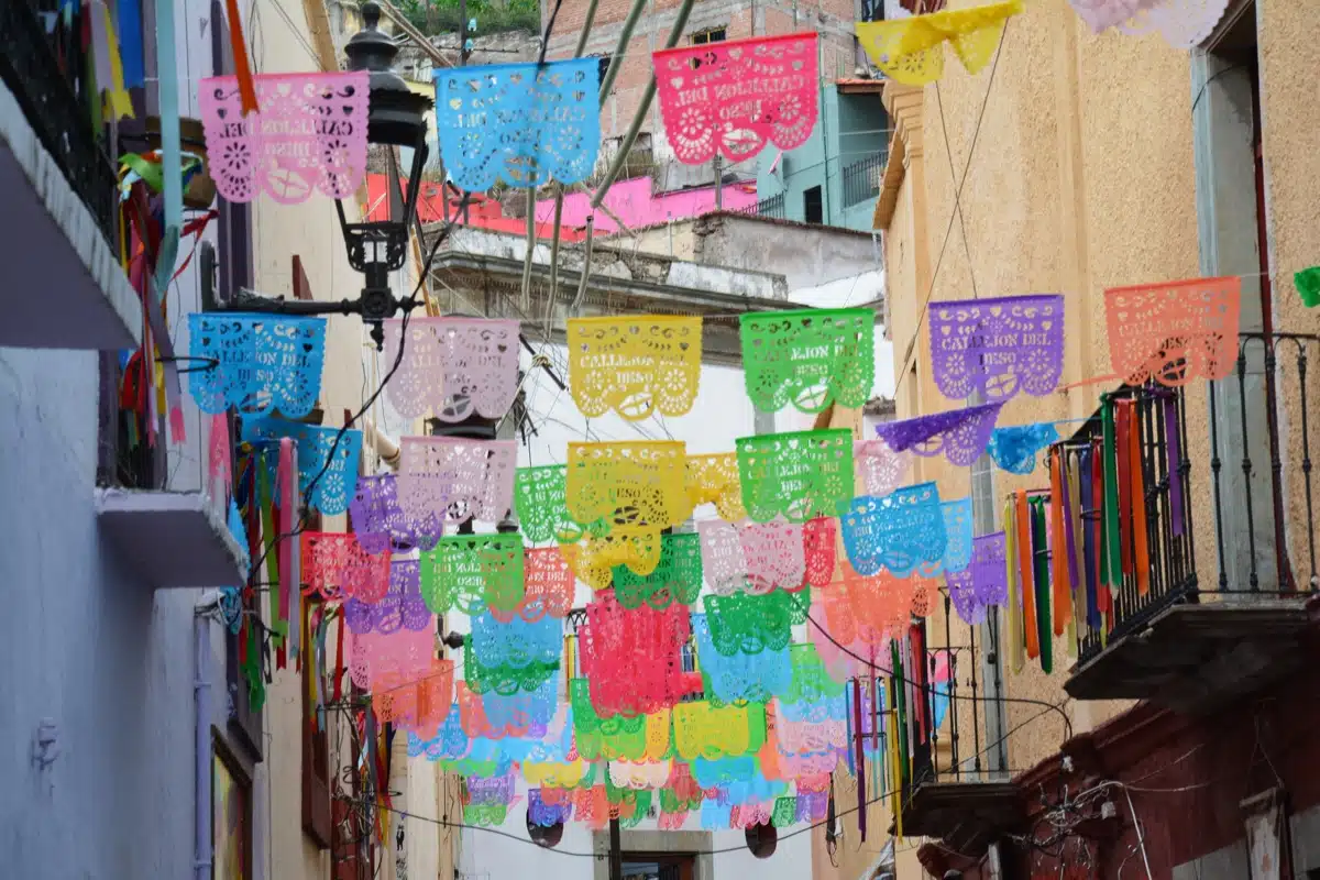 Celebrate Día de los Muertos at the Eiteljorg on Oct. 24 2 Colorful papel picado banners hang across a street