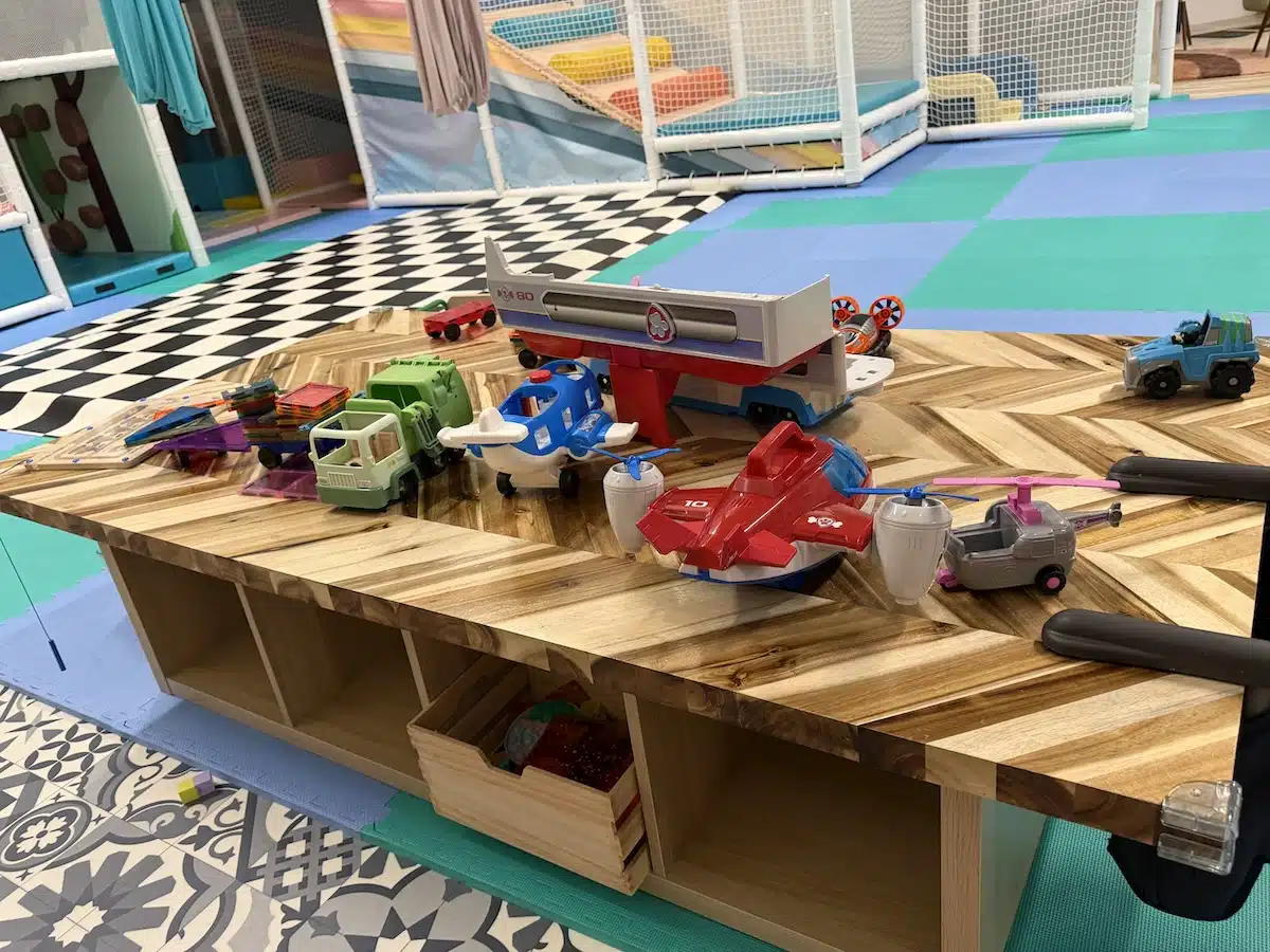 Inside Prana Play, a Sensory-Friendly Play Space in Carmel 7 Toy vehicles on a play table at Prana Play