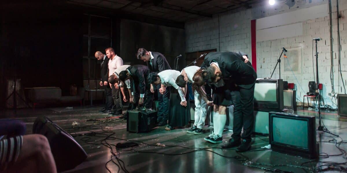 A cast taking a bow on stage after a performance