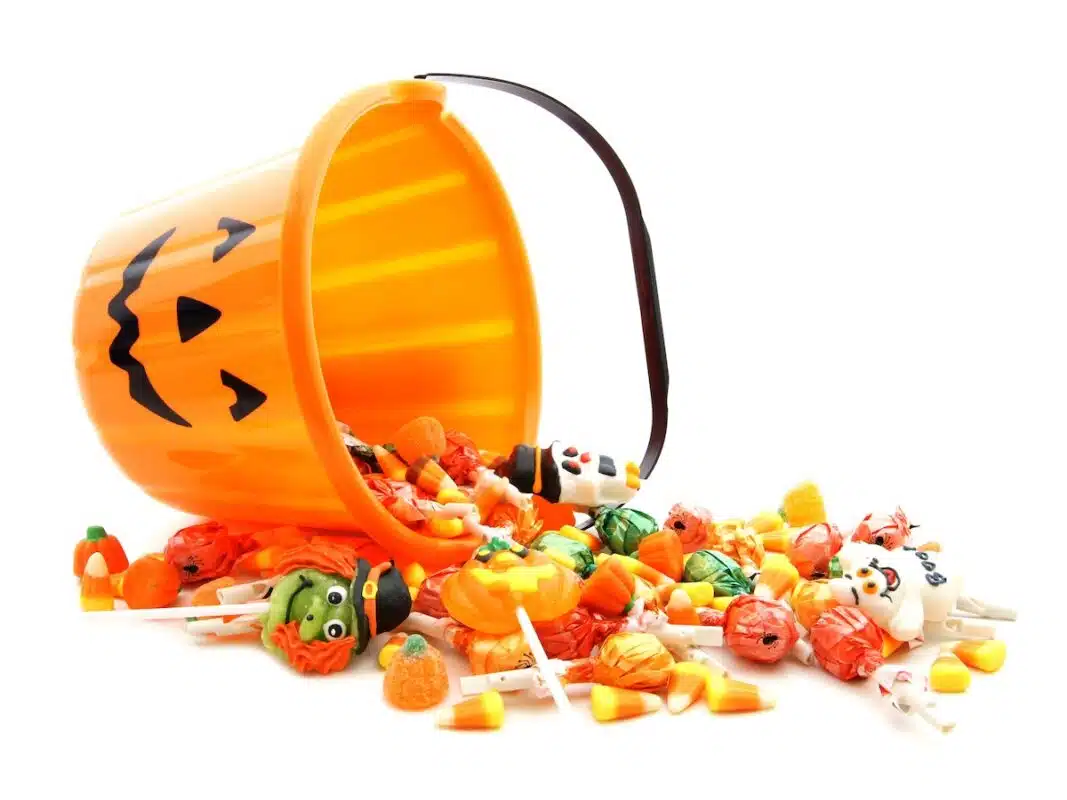 Jack-o'-lantern pail with candy spilling out