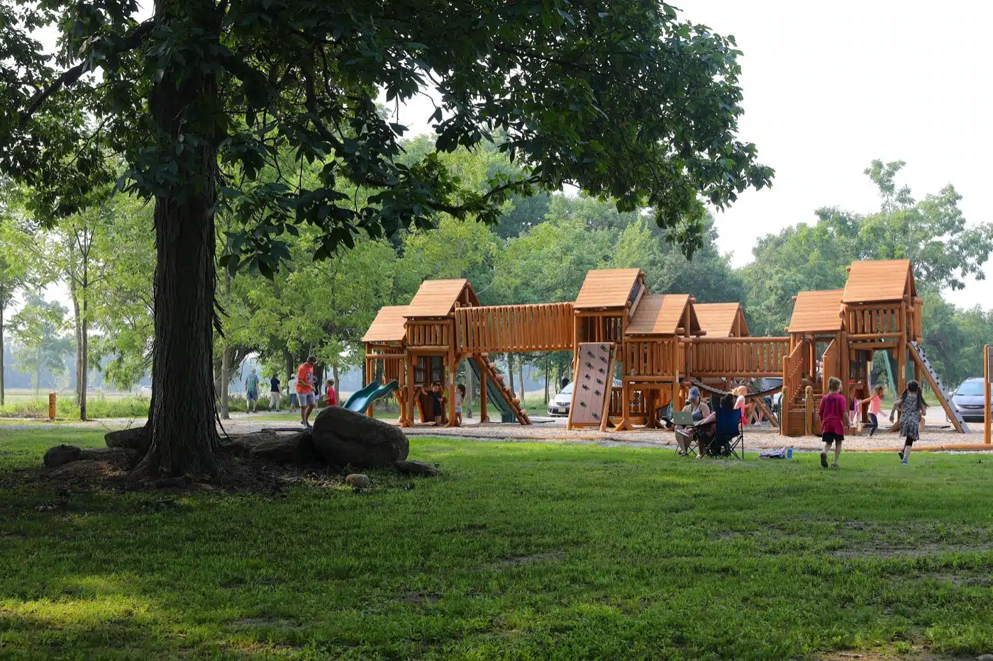 Things to Do in Avon with Kids (2026) 1 Wooden nature-themed playground towers under shade trees at W.S. Gibbs Memorial Park in Avon