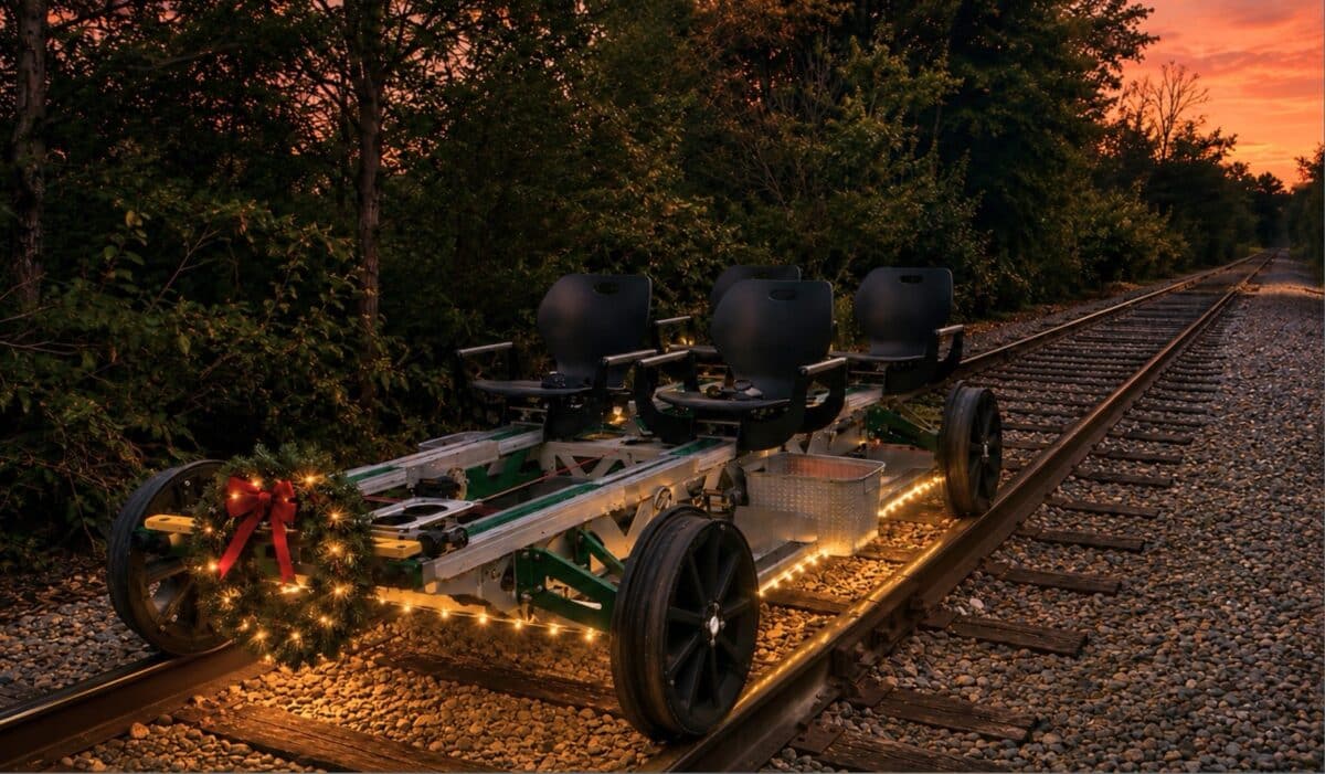 A four-seat railbike decorated with a lighted wreath on the Nickel Plate tracks in Noblesville