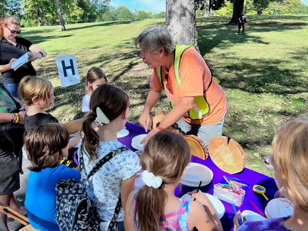 Children gathered around an outdoor education table at Crown Hill