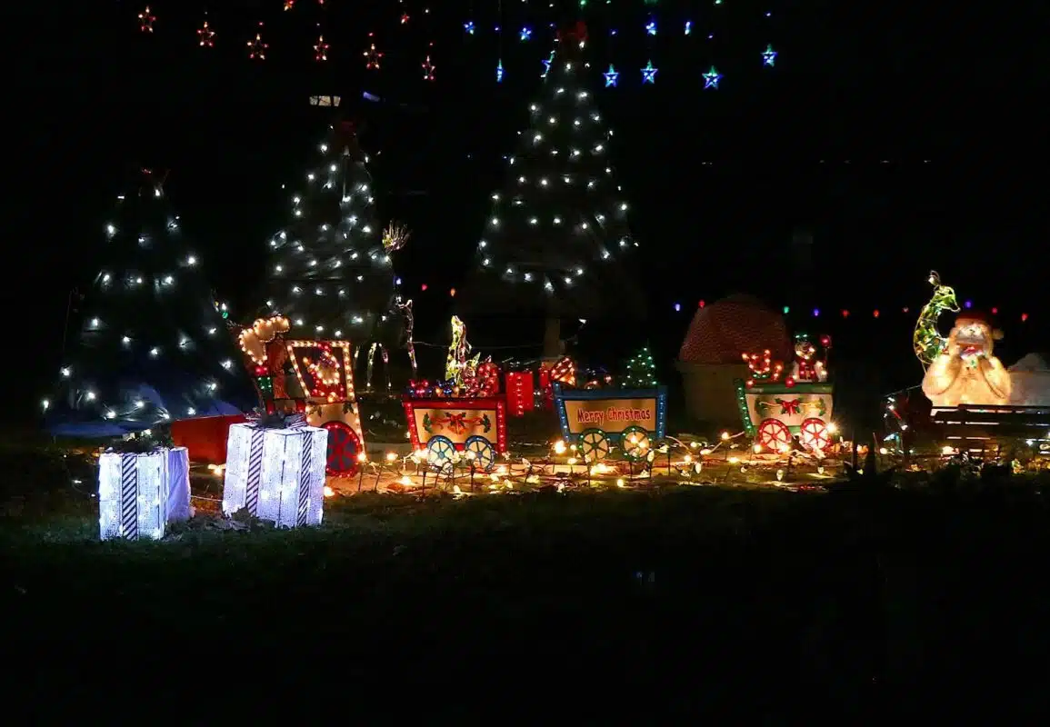 A campsite decorated with lighted Christmas trees and holiday displays at Nights of Lights in Mounds State Park