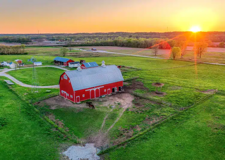 The red barn at The Farm at Prophetstown State Park at sunset