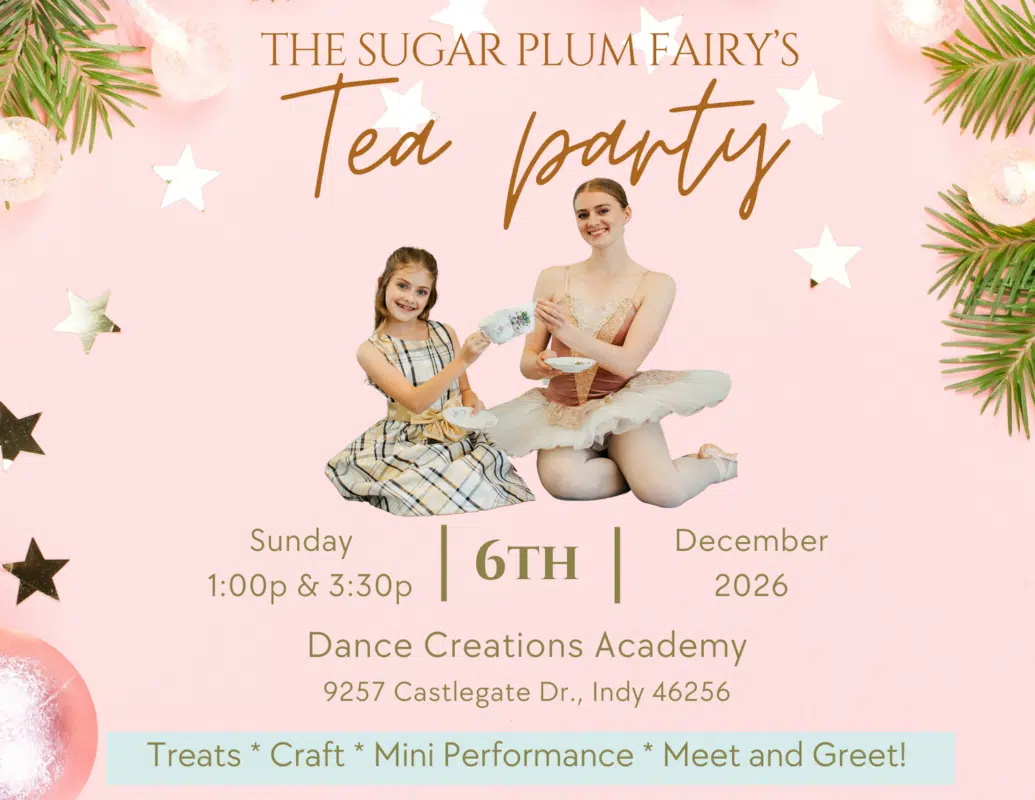 A young girl having tea with a ballerina dressed as the Sugar Plum Fairy